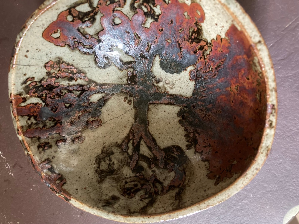 A bowl with a red and brown design.