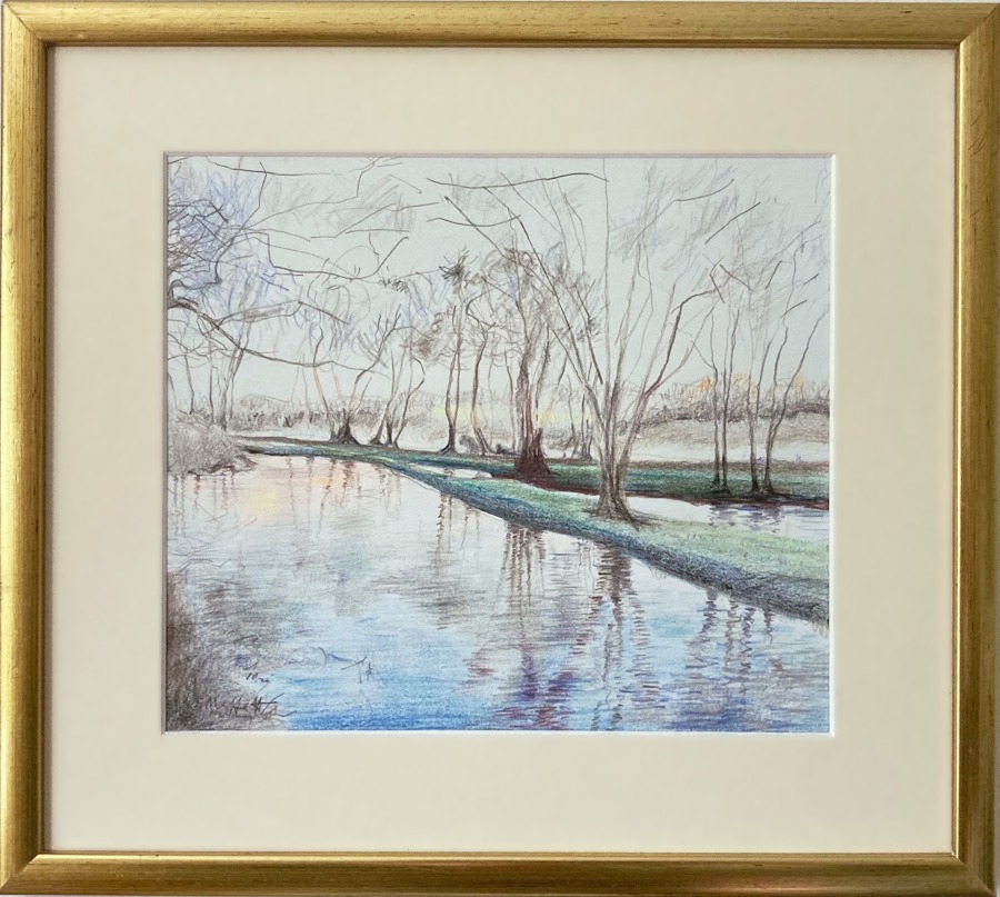 A framed picture of a riverbank at dawn.