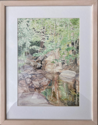 A framed picture of a stream.