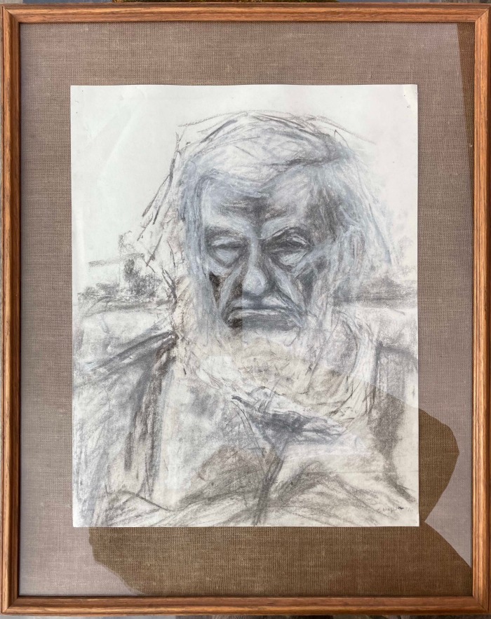 A framed charcoal drawing of an elderly man.